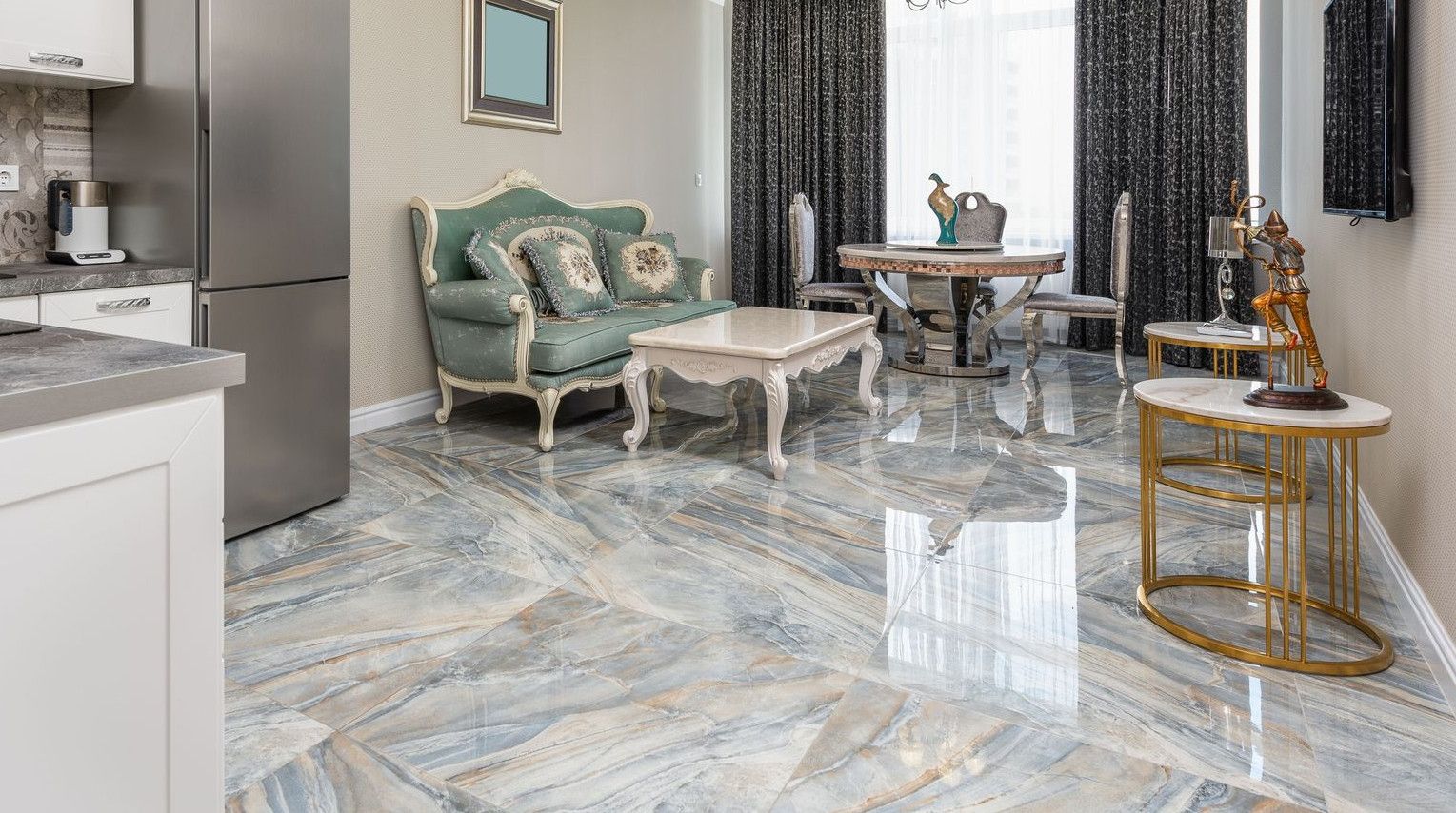 Classic living room and modern kitchen interior with tables against couch and refrigerator on marble floor at home
