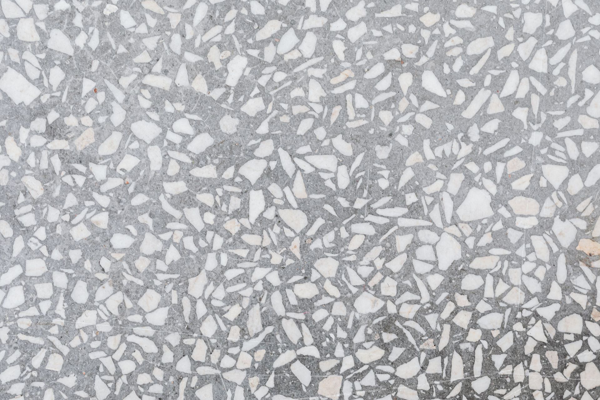 High-resolution image of a classic terrazzo stone texture with white and gray patterns.